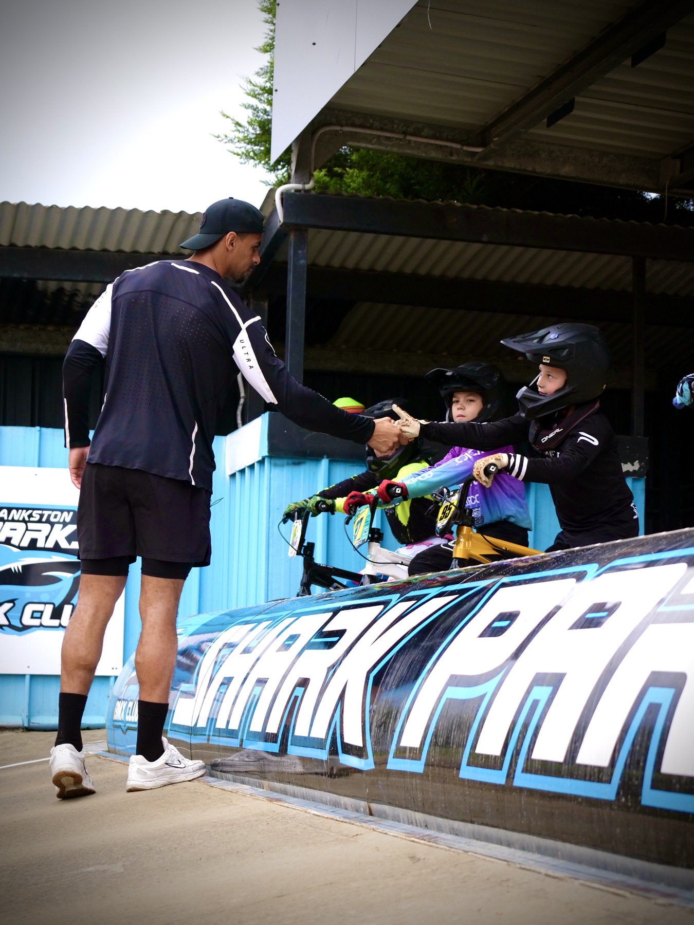Quillan Isidore shaking hands with a young BMX rider