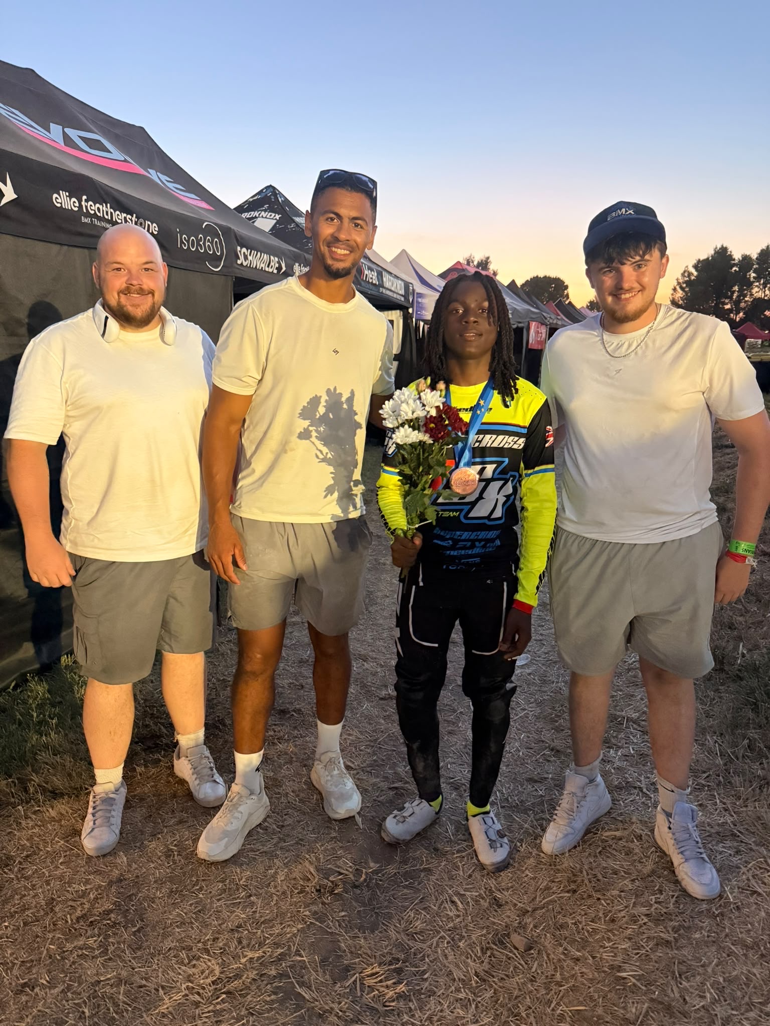Coaching team celebrating with a podium rider
