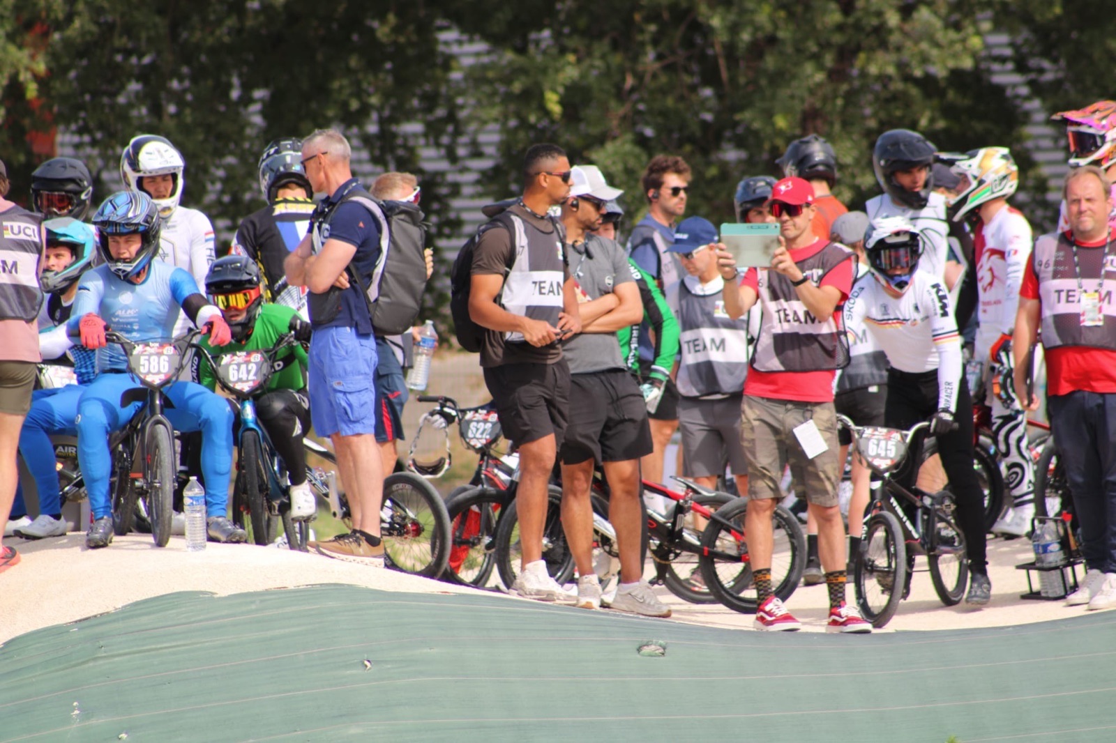 Quillan coaching among riders in the race staging area