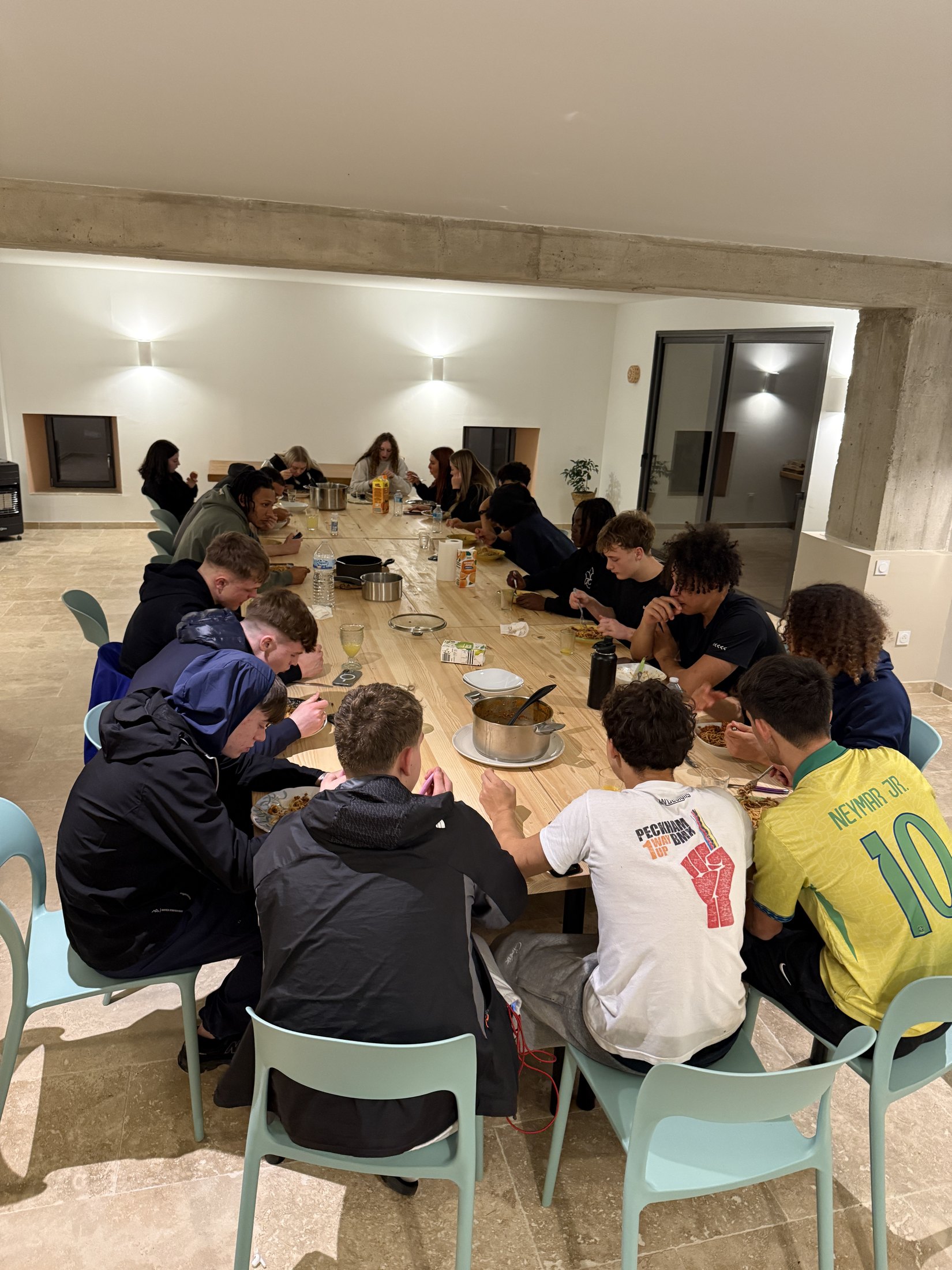 Training camp group sharing an evening meal